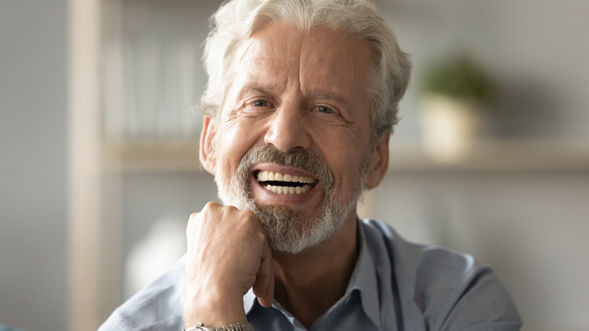 Portrait elderly man with candid wide smile looking