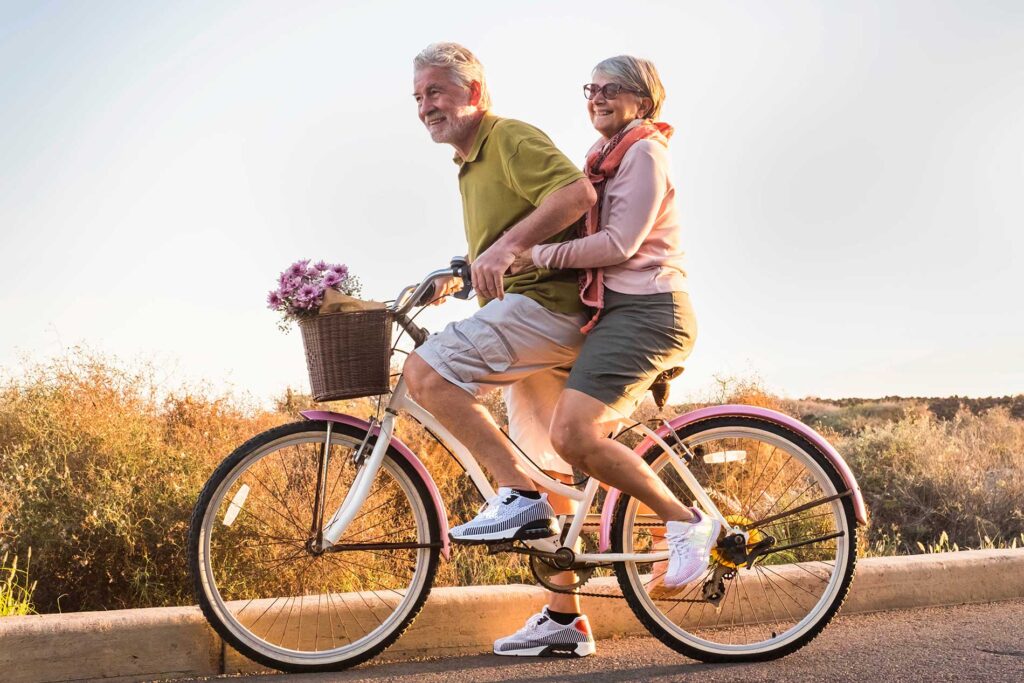 couple-biking-down-a-road