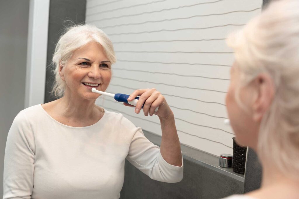 elderly person brushing there teeth