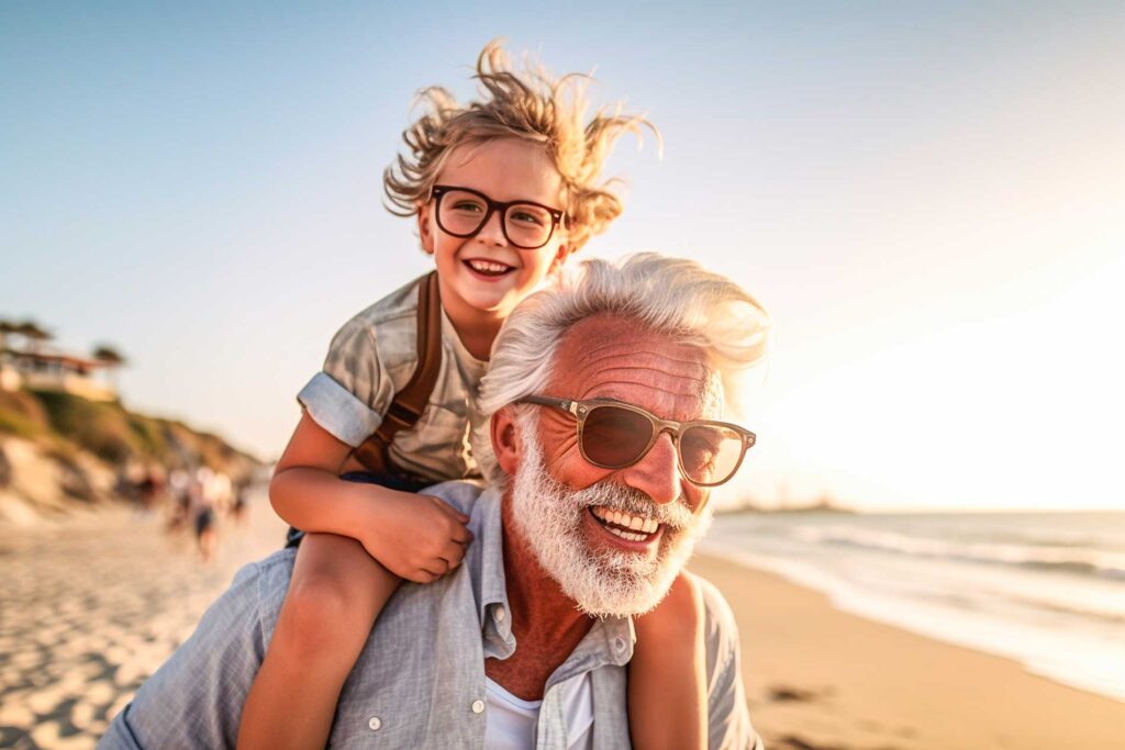Happy senior man and his grandson on the beach