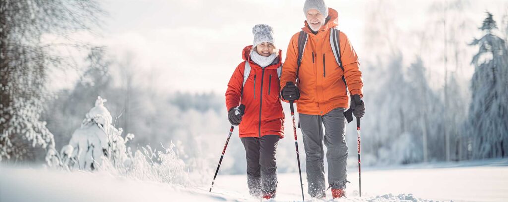 couple smiling and skiing along the snow