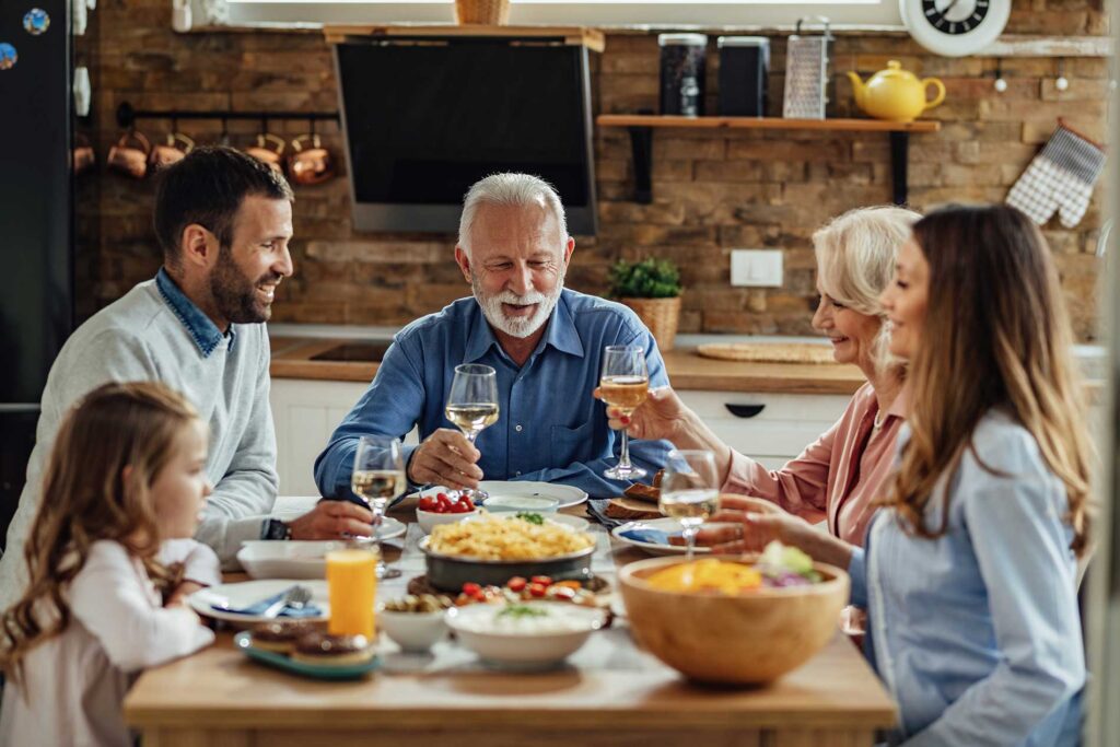 group of people sitting at the table having a meal