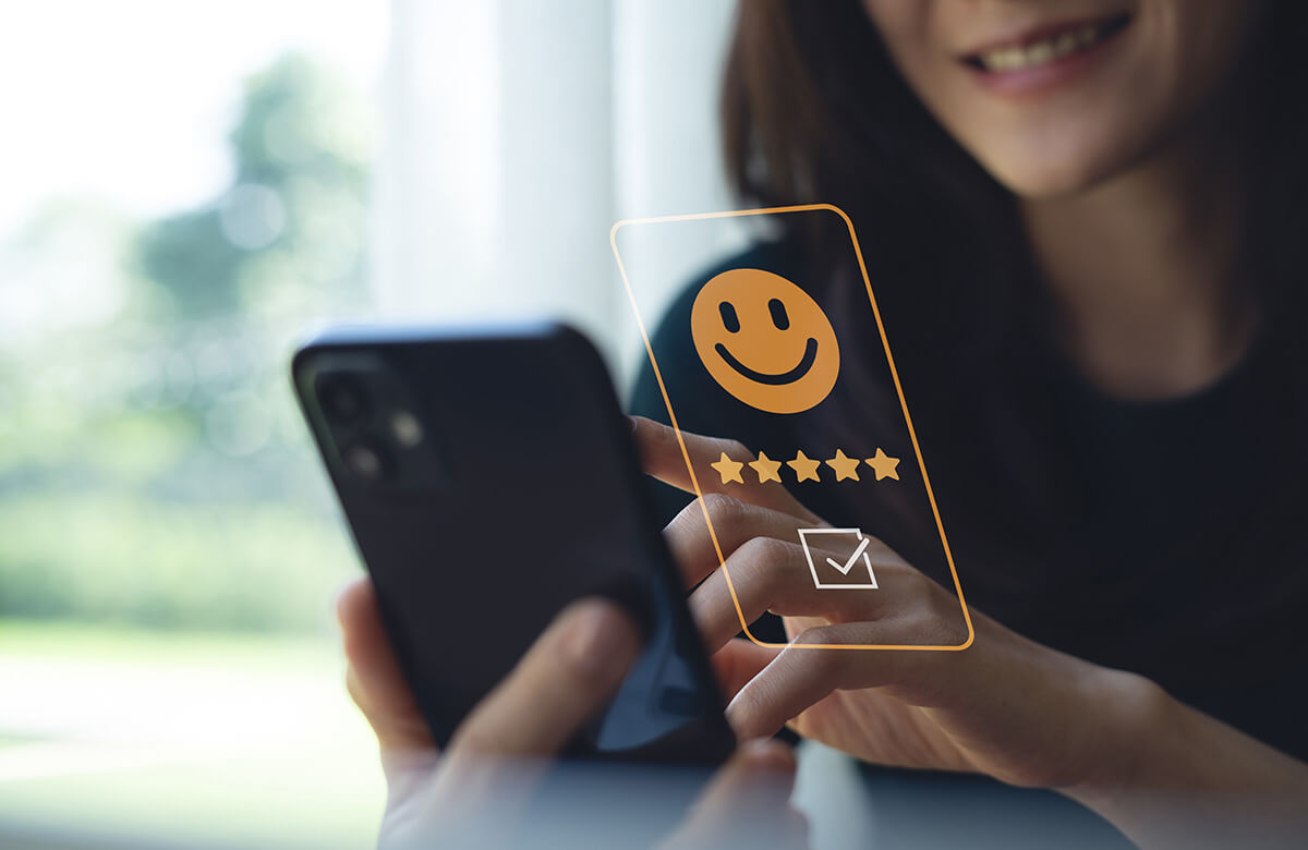 Customer pressing smile face and five star on mobile phone