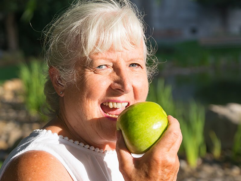 Elderly woman eating healthy outdoors Elderly woman eating healthy outdoors