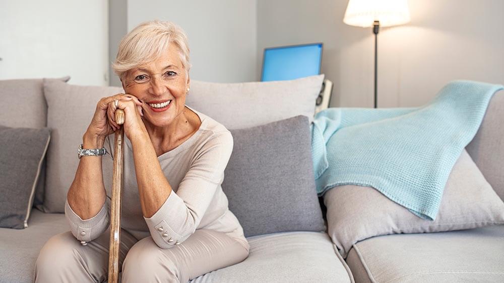 Smiling grandmother sitting on couch