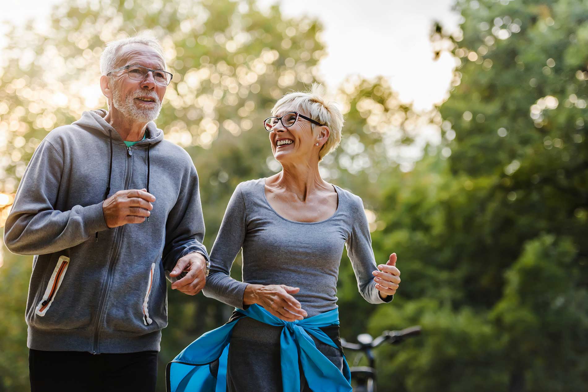 two-seniors-have-a-jog-along-a-road